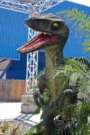 a life sized dinosaur lurks in the bushes