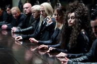 witches and wizards sit at a long table in a scene from Harry Potter and the Deathly Hallows
