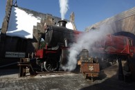 steam locomotive pulling in to the town of Hogsmeade