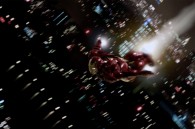 Iron Man flying over a night cityscape